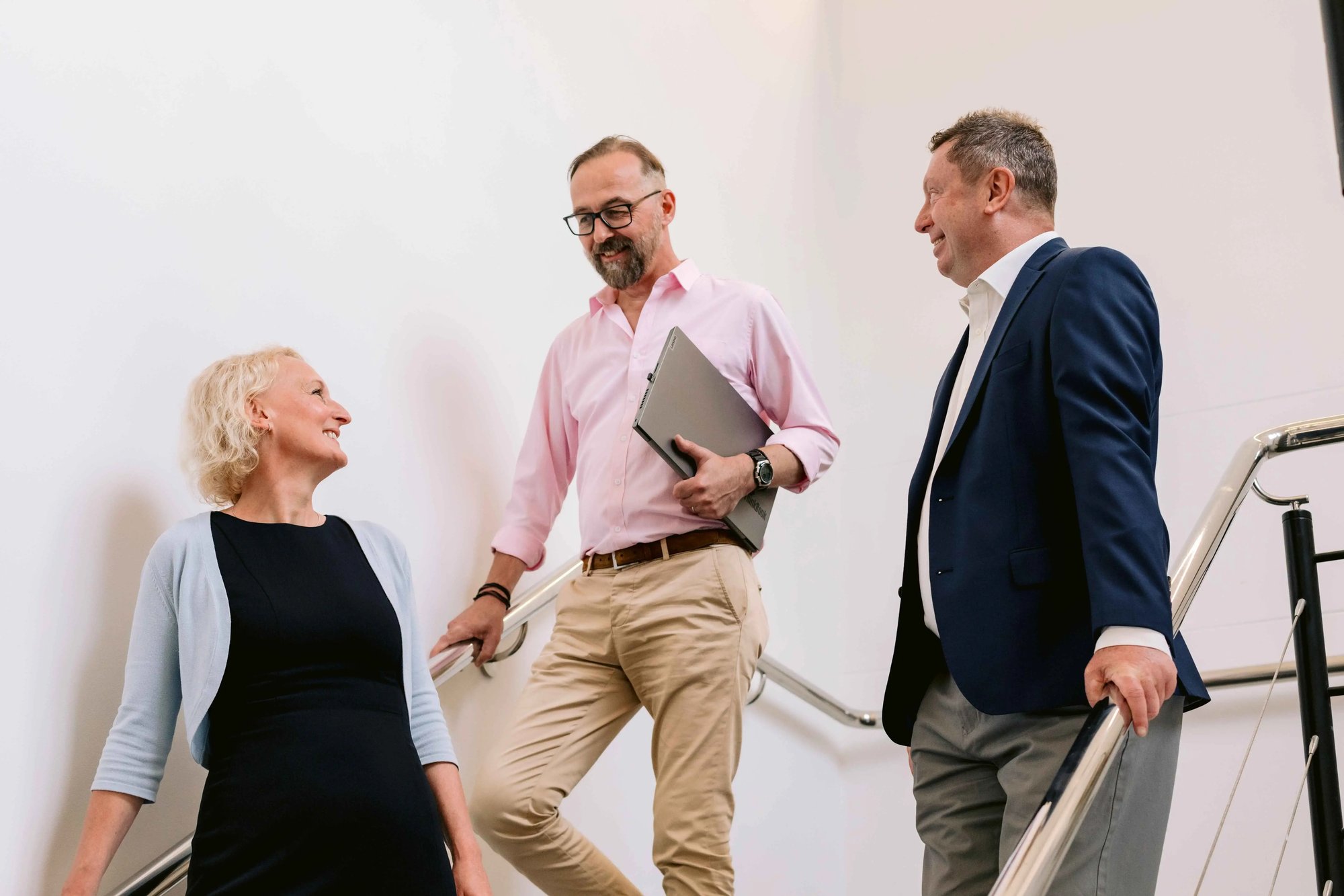 Colleagues having a discussion on the way out of a meeting