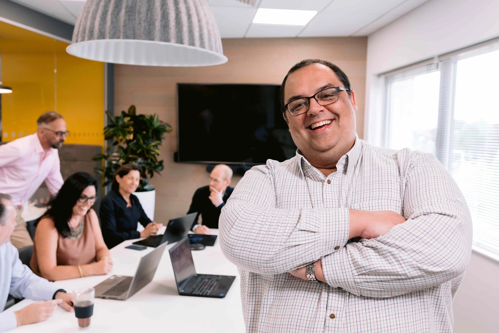 James, a CapEQ expert, is folding his arms and smiling at the camera