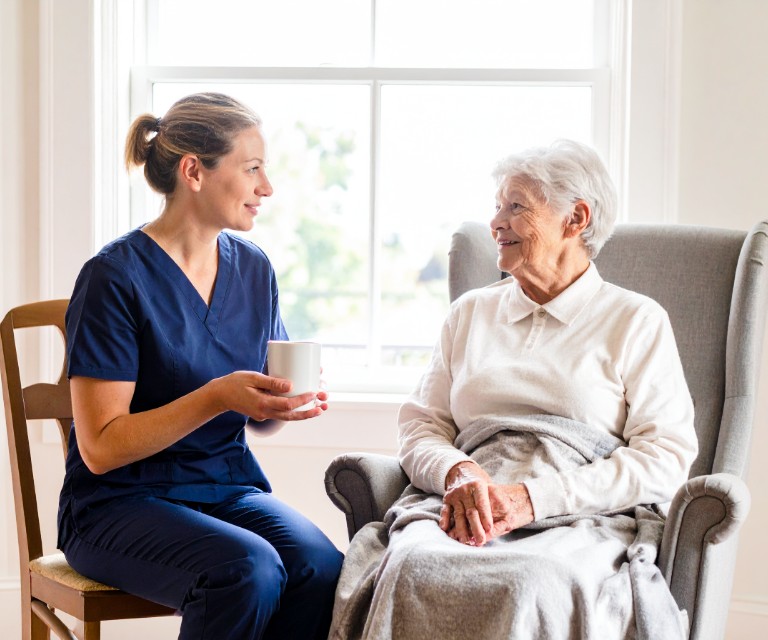 Home carer supporting an older client at home in Eastbourne, East Sussex