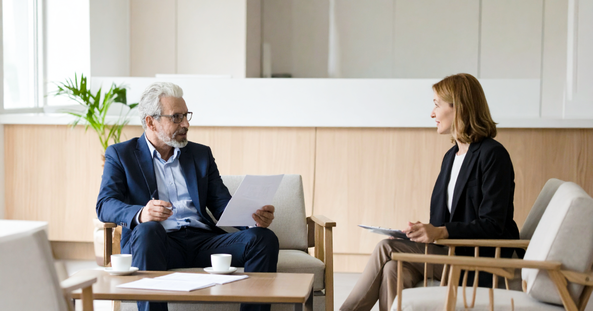 Founder with M&A advisor discussiing warranties and indemnities in acquisition negotiations