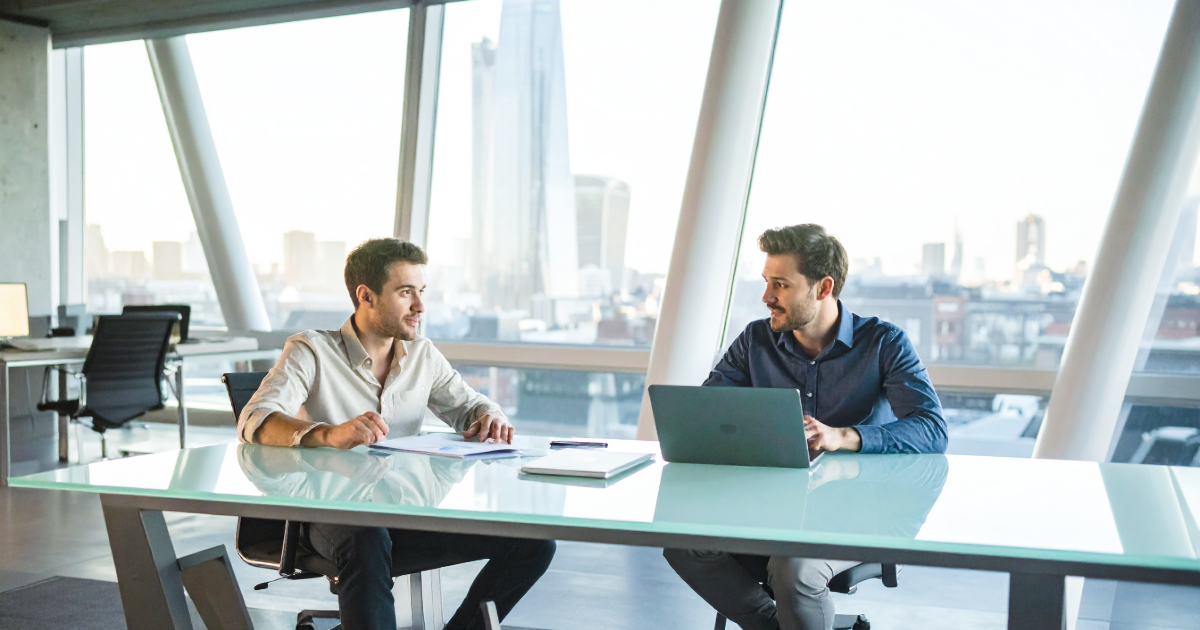 Two young founders reviewing growth financing options together in a modern London office.